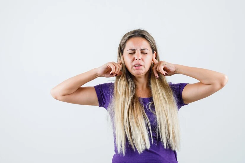 Woman experiencing ear pain, ICD-10 Codes for Ear Pain.